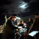 Charles Bridge Preformer under winter's full moon